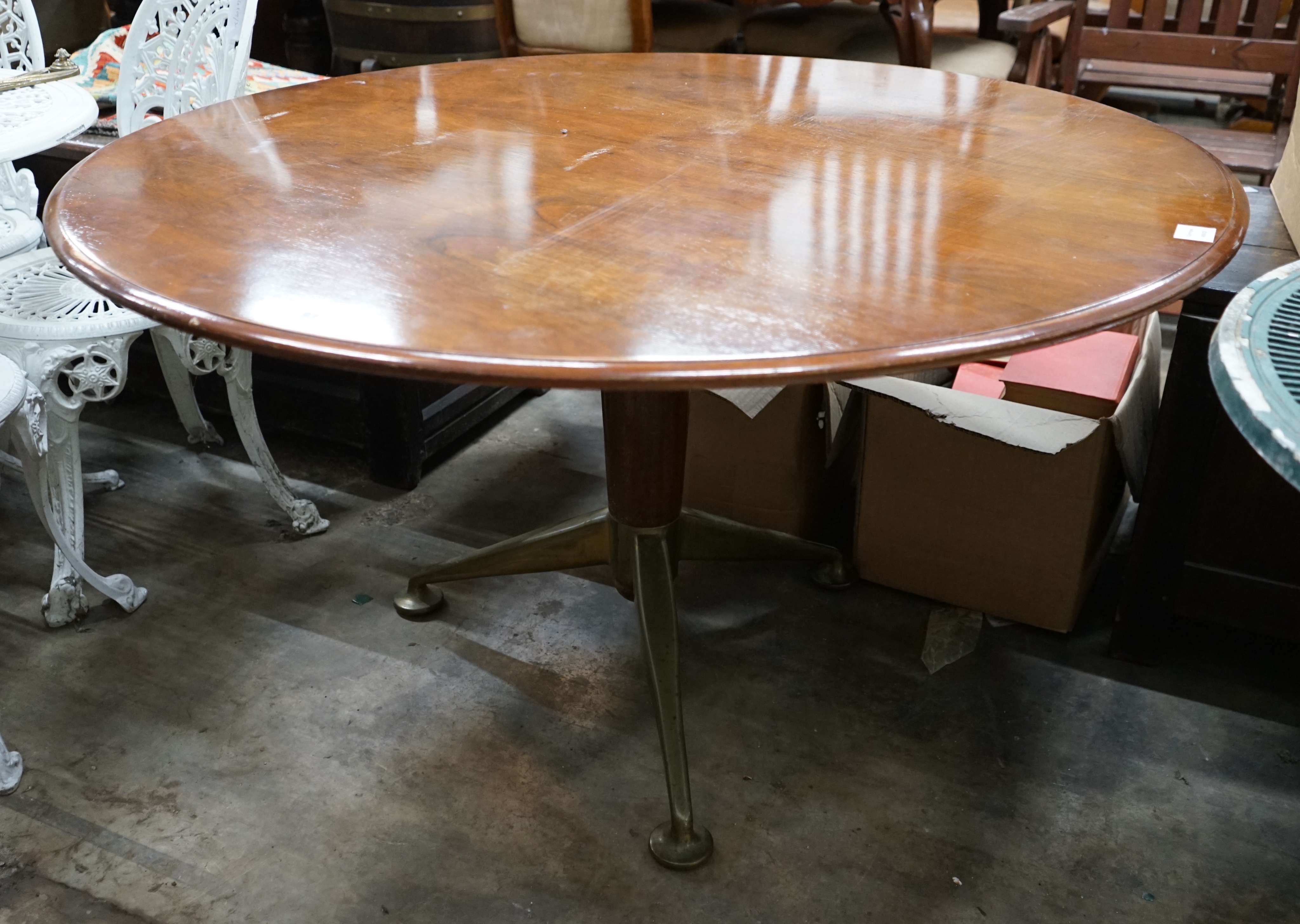 A mid century design circular centre table, on spoked metal base, width 122cm height 67cm